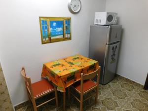 德雷斯Apartments Kalafatović的一张带两把椅子的小桌子和一台冰箱