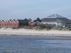 奥斯特赫鲁普Feriecenter & Vandland Øster Hurup的海边一排红房子