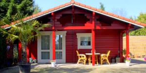 HegelsomVakantiewoning Hegga的前面有一张桌子和椅子的红色房子