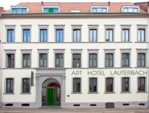 凯撒斯劳滕劳特巴赫艺术酒店的白色的建筑,前面有标志