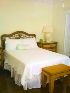Smiths Point SettlementThe Blue Inn Family Vacation Rental的卧室配有白色的床和木制床头板