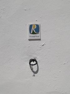 卡萨韦梅哈La Casa de Corruco的白色墙边的标志