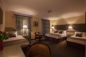 ArvaghBreffni Arms Hotel的酒店客房配有两张床和一张书桌