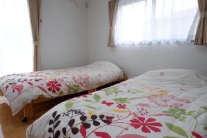 屋久岛古太郎度假屋的卧室内两张并排的床