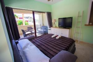 内尔哈Burriana Beach Apartment的一间卧室配有一张沙发床和一台电视。