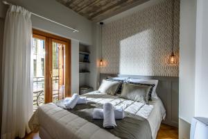 海若克利欧坎地亚套房及客房公寓式酒店的一间卧室配有一张大床和毛巾