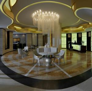 迪拜达玛克大厦庭院花园公寓式酒店的大堂设有吊灯、沙发和椅子