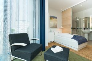 韦斯特兰Hotel Niedersachsen的一间卧室配有一张床和一把椅子