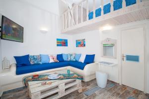 卡马利蓝色梦幻圣托里尼公寓的客厅设有蓝色的沙发和楼梯。