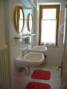 圣马蒂诺-迪卡斯特罗扎Ostello SanMartino的浴室设有2个水槽和2个镜子