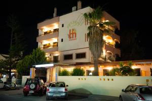 伊利索斯Heleni Beach Hotel的一座建筑,晚上停在前面