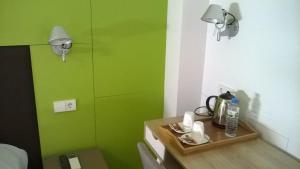 伊维萨镇Huéspedes Sa Font的绿色的客房设有一张桌子和绿色的墙壁