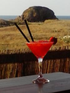 卡斯特罗波尔Hostal Restaurante Parajes的坐在桌子上的马提尼玻璃上的红饮料
