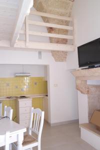 普雷西切Casa Vacanze Presicce的一间带桌椅和楼梯的厨房