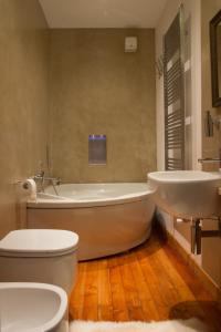 阿兰尼亚·瓦尔塞西娅自由的三棵树酒店的带浴缸、卫生间和盥洗盆的浴室