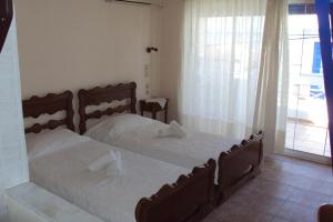 LímniOnar的一间卧室设有两张床和一个美景窗户。