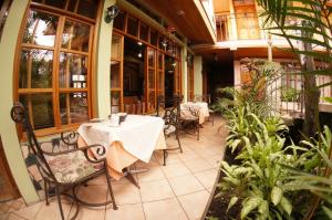 Jinotega咖啡厅酒店的庭院中设有1间带桌椅的餐厅