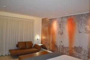 圣安东尼奥马菲尔酒店的客厅配有椅子和墙壁,墙壁上涂有生锈的油漆