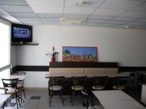 布里夫拉盖亚尔德布瑞福艾斯酒店的一间带桌椅的用餐室和一台墙上的电视