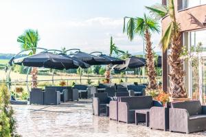 卢切内茨Miraj Resort的庭院里摆放着一排椅子和遮阳伞