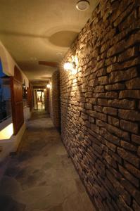 白滨鲁安冬白滨酒店的走廊上设有砖墙,上面有灯