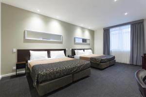 墨尔本墨尔本南方大酒店的酒店客房设有两张床和窗户。