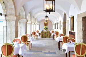 帕尔梅拉帕梅拉堡酒店的餐厅位于带天花板的走廊,配有桌椅。