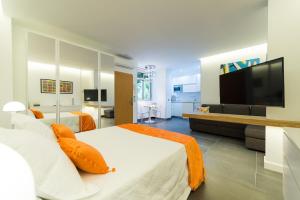大加那利岛拉斯帕尔马斯Suites Garden Loft Miro的一间卧室配有两张床和一台平面电视