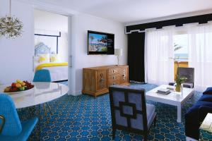 棕榈滩水棕榈海滩度假酒店暨Spa的一间带床的客厅和一间带客厅的客厅