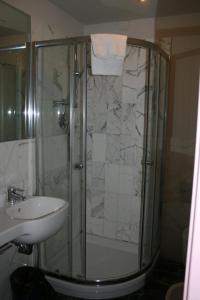 托尔托纳奥尔伯格卡瓦利诺酒店的水槽旁的玻璃门淋浴