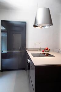 米兰索尔费里诺套房公寓的厨房配有水槽和玻璃淋浴间