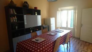 比萨Francesca House的厨房配有一张带红白桌布的桌子