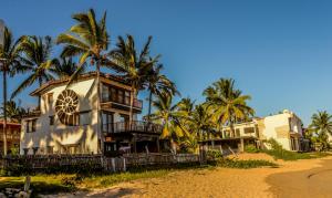 比亚米尔港Casa Baronesa Waterfront Villa的棕榈树海滩上的房子