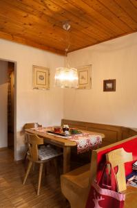 卡雷扎湖Casa al Lago di Carezza - Dolomiti的一间带桌子和吊灯的用餐室