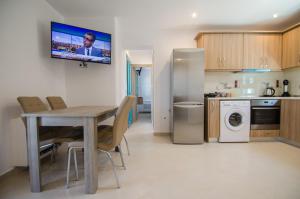 伊奥斯乔拉Ios Sea View的厨房配有桌椅和冰箱。