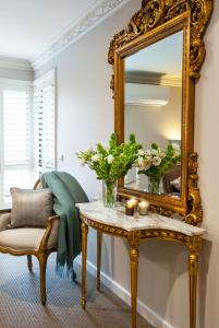 丹德农山Villa d'Amour的镜子和一张带鲜花的桌子