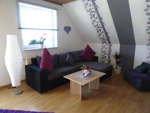 CaldenPension und Apartment Landhaus Fricke的客厅配有黑色沙发和桌子