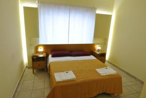 罗马罗马旅游之家旅馆的一间卧室配有一张床,上面有两条毛巾