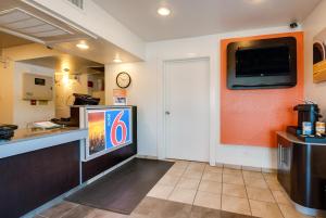 雷内克萨堪萨斯城西南列涅萨号6汽车旅馆的一间配有电视和柜台的等候室