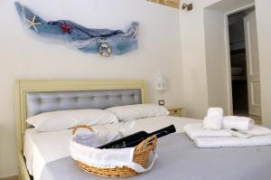 加利波利Palazzo Piccioli的一间卧室配有两张床,床上有一个篮子