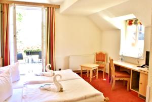德累斯顿阿托奇维策霍夫酒店的两个天鹅坐在酒店房间的床边