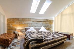 拜罗伊特Villa Johner的一间卧室设有一张大床和石墙
