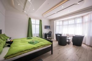 伯尔尼麦克斯航空别墅&公寓旅馆的一间卧室配有绿色的床和桌椅