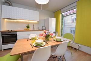 塔林Bright Home的厨房配有带白色椅子的木桌和用餐室。