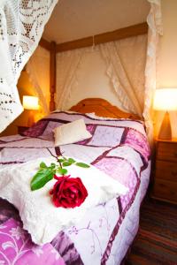 Saint CletherThe Old Wagon House的床上坐着红玫瑰
