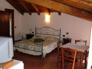 皮尼奥内拉美丽迪安娜卡萨莱酒店的一间卧室配有一张床和一张桌子