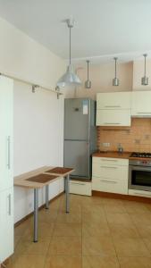 伏尔加格勒Apartment on Lenina 44的带冰箱和桌子的厨房