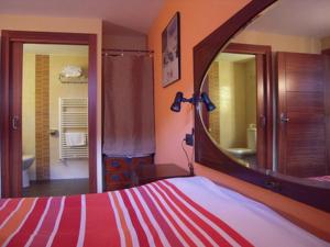 HerrerosCasa Rural Apartamento El Chaveto的一间卧室配有一张带大镜子的床