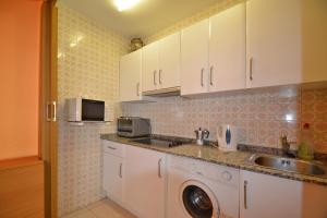 萨洛Apartamento en Salou的厨房配有水槽和洗衣机