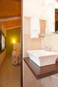 Villar de CañasUn Rincón en la Mancha的一间带水槽的浴室和一间带床的房间